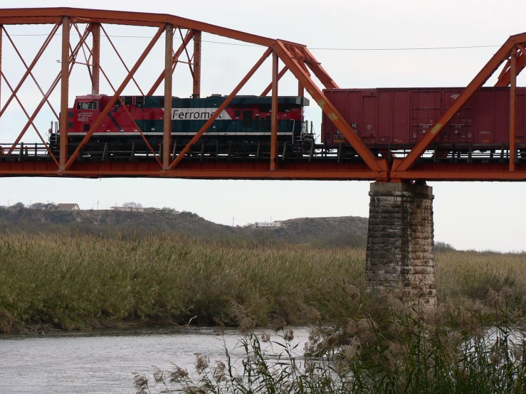 a train crossing over a bridge over a river