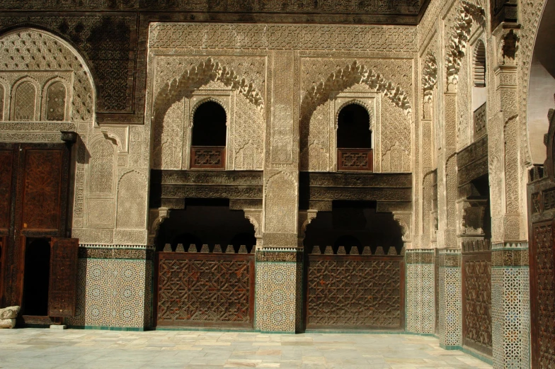 the interior of an old building with several ornate columns and doors