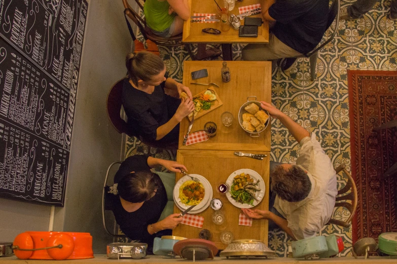 three people at a table eating dinner together