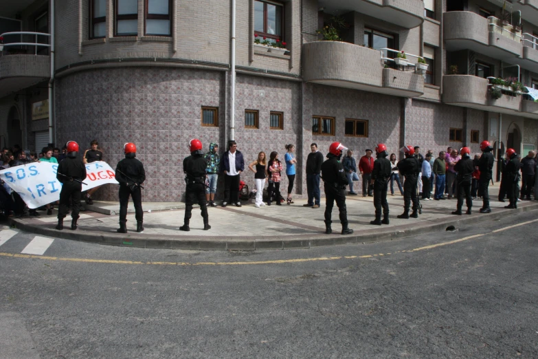 a group of police standing next to each other on the street