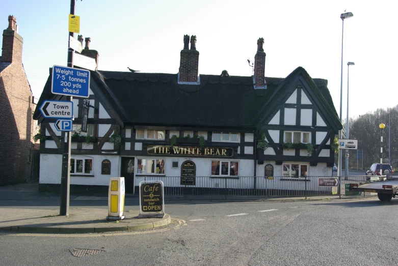 a long building with many windows and signs in front of it