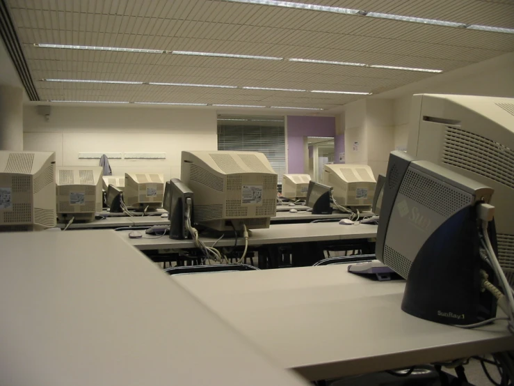 a room with computers and desks are on display