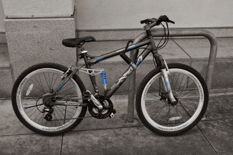 a bicycle parked next to a bike rack