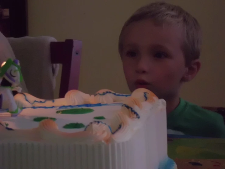 a  standing next to a birthday cake