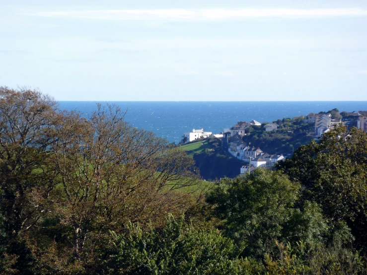 a view of a small town next to the ocean