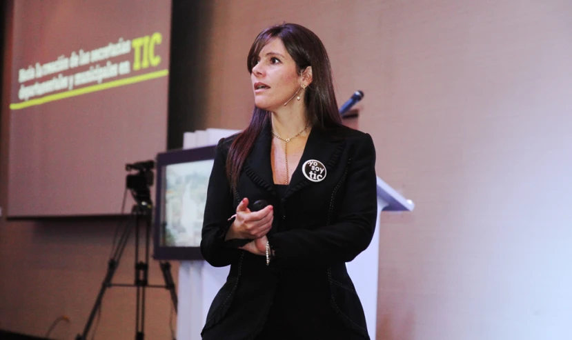 an image of woman speaking on stage at a business meeting