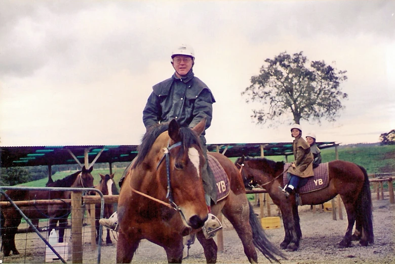 a man riding on the back of a brown horse