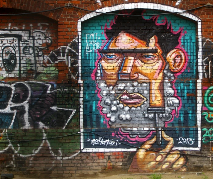 graffiti on a wall with various pieces of art