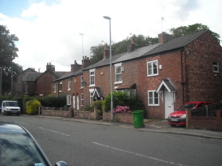 two small brick townhouses along a road