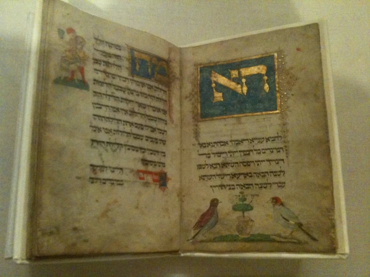 an old book is opened with an arabic script