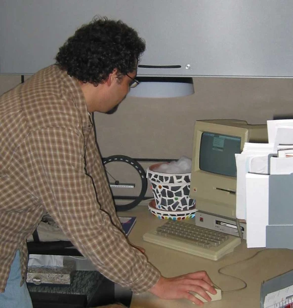a man sitting at a desk typing on a computer
