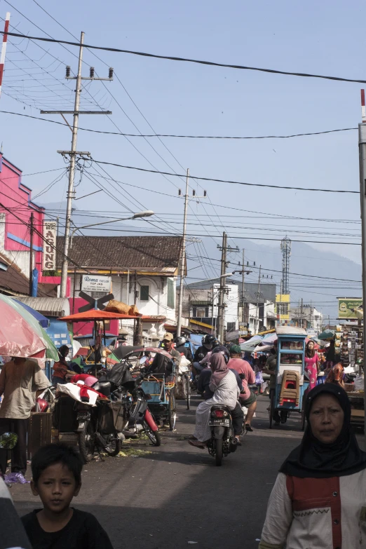 a busy street has many pedestrians walking by