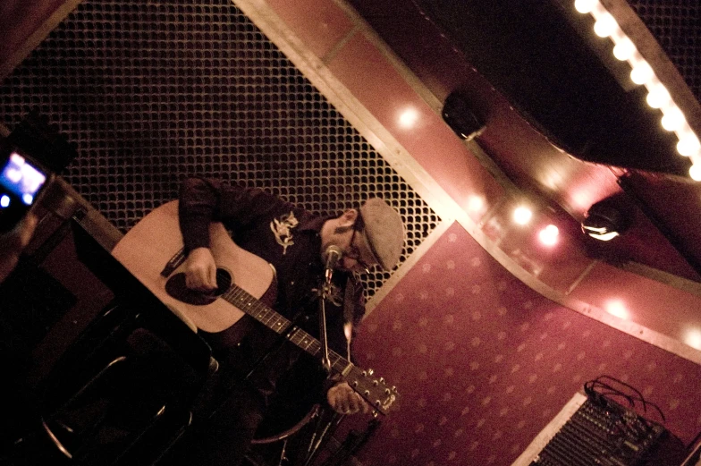 guitar in a room with lights and a cell phone