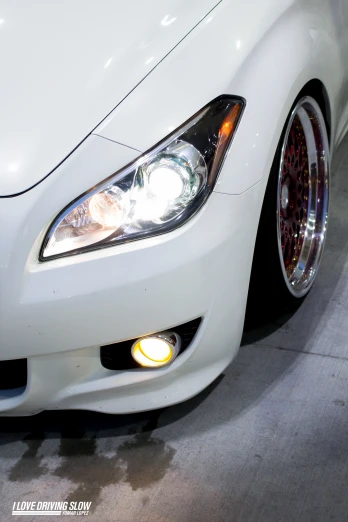 the front end of a white sports car