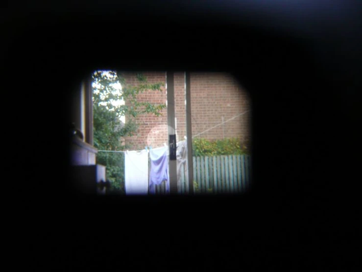 an open window shows clothes on the line