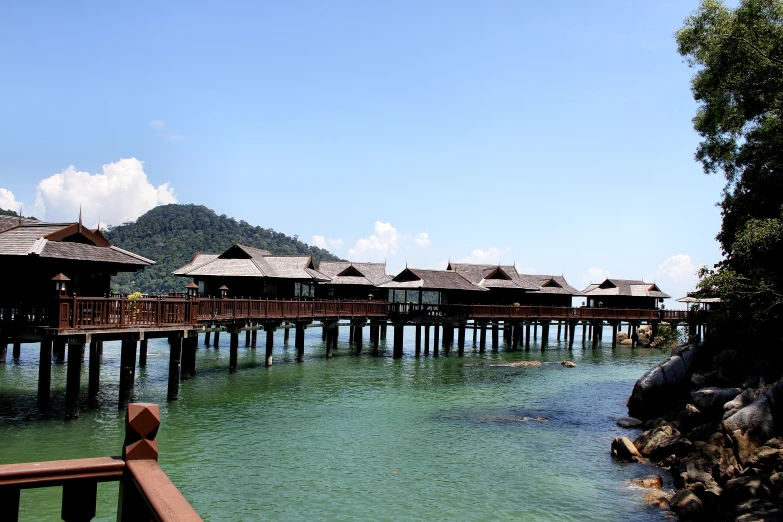 some brown and white buildings on water and rocks