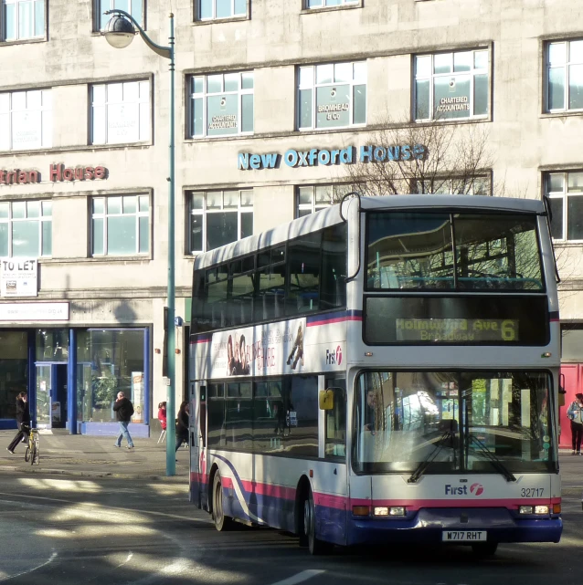 a double decker bus driving down a street