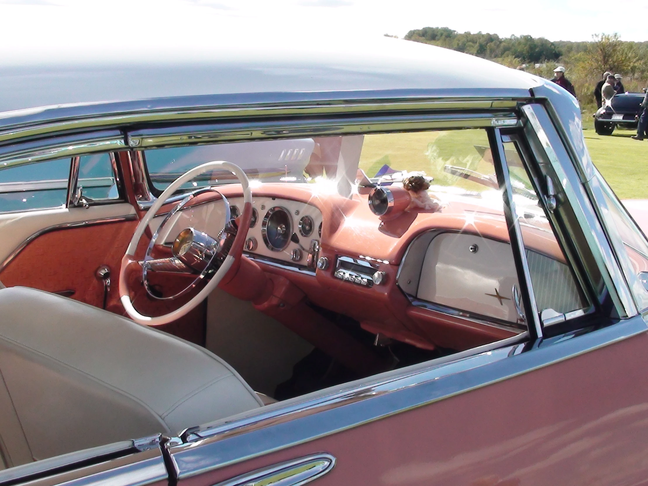 a classic car sits in front of some other cars