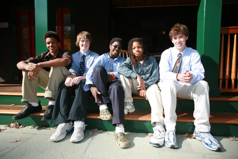 a group of young people sitting on top of wooden steps