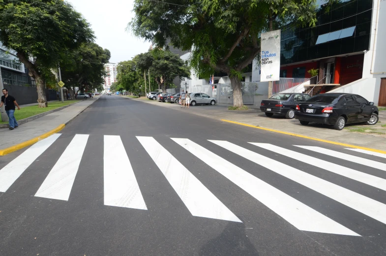 a cross walk with white painted lines is shown