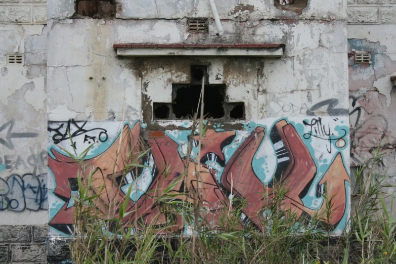 a building with graffiti on the side and a broken window