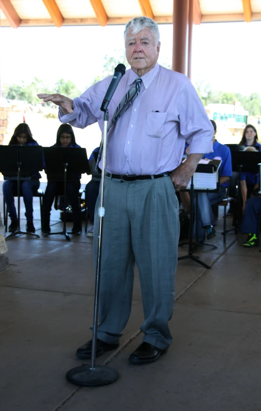 a man is standing up holding a microphone