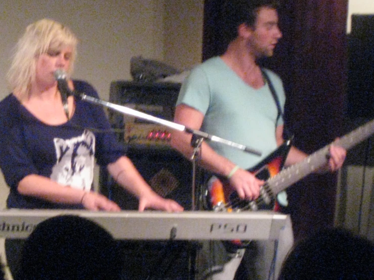 a man and woman that are on stage with some music instruments