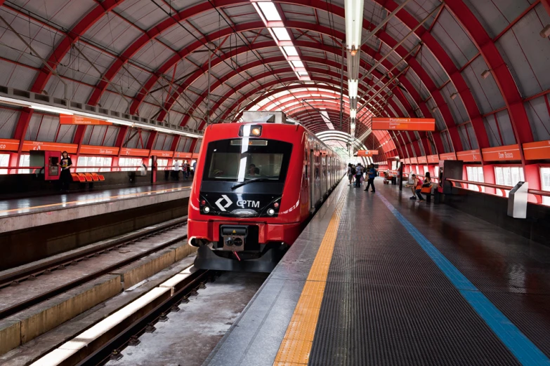 a train pulling up to an open air station