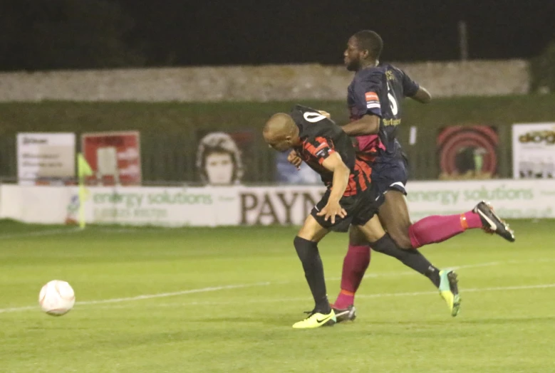 two men on a field playing soccer