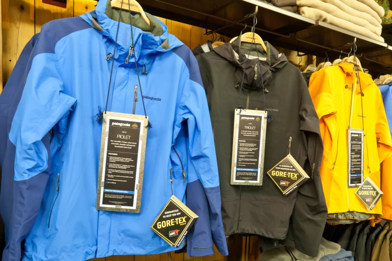 rain coats hanging on a rack in a store