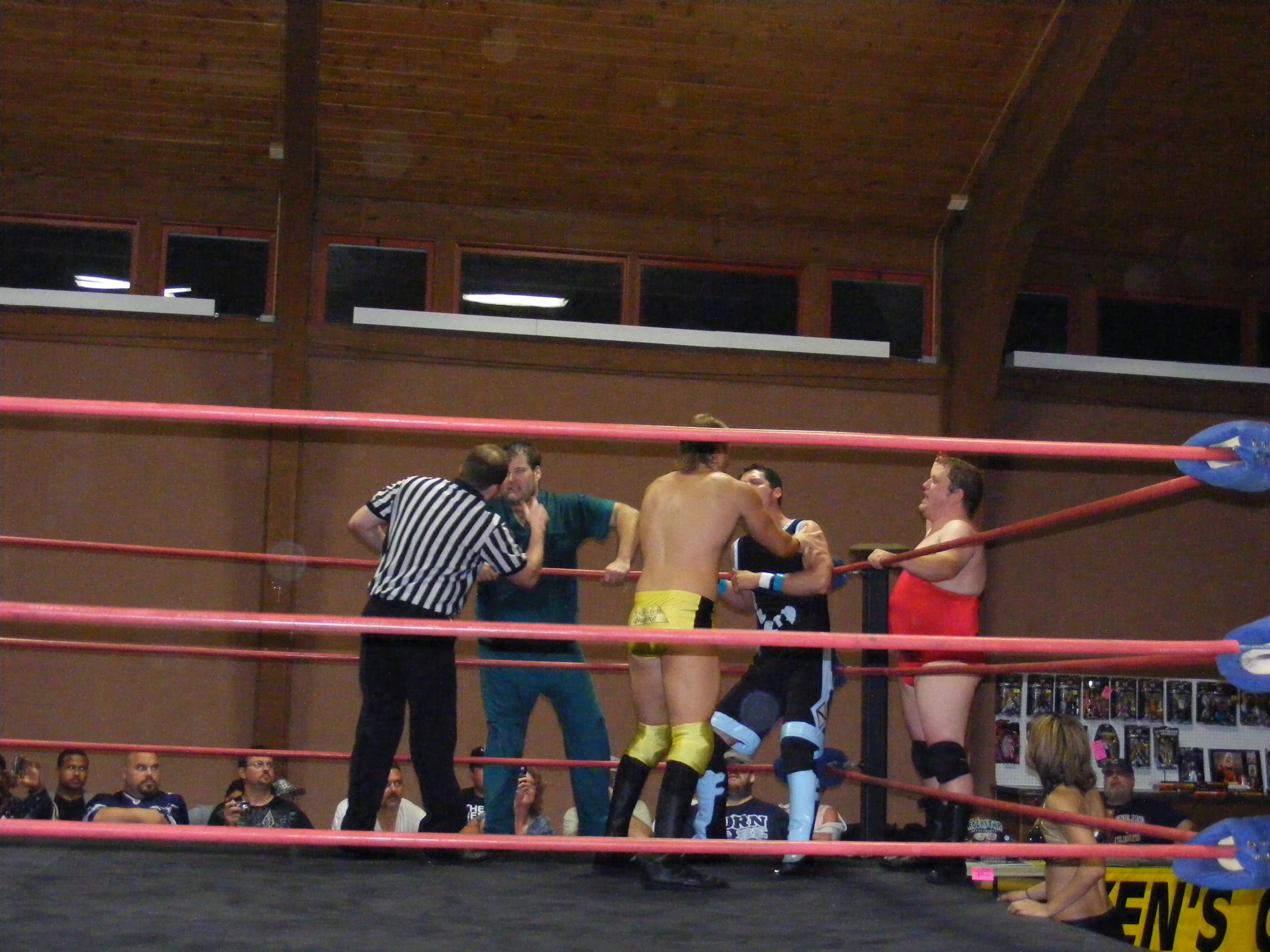 two women and one man standing around with a referee