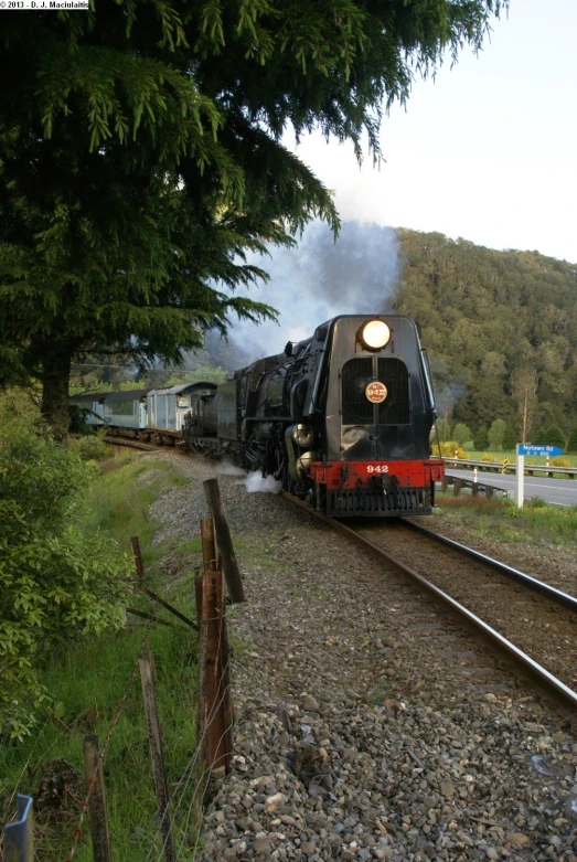 a train on a train track near some trees