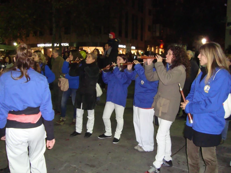 a group of women take pictures together in the street