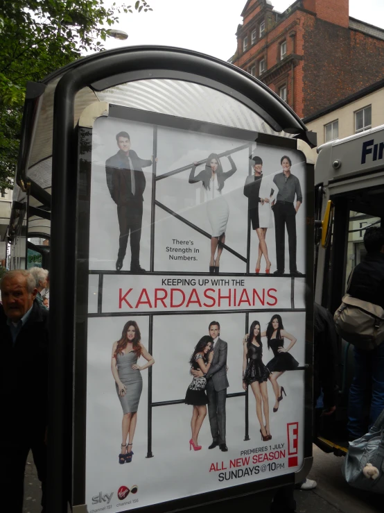 a poster on a bus for kardashians on the street