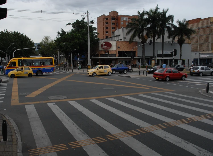 a street corner with a bus and cars on the street