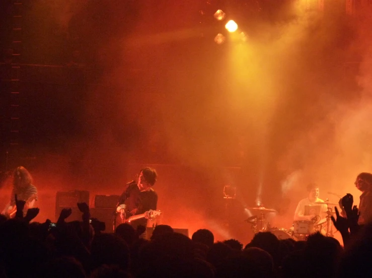 concert in front of large crowd, with one person singing