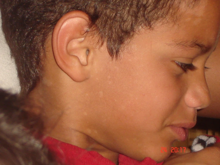 a child with a piercing on his ear