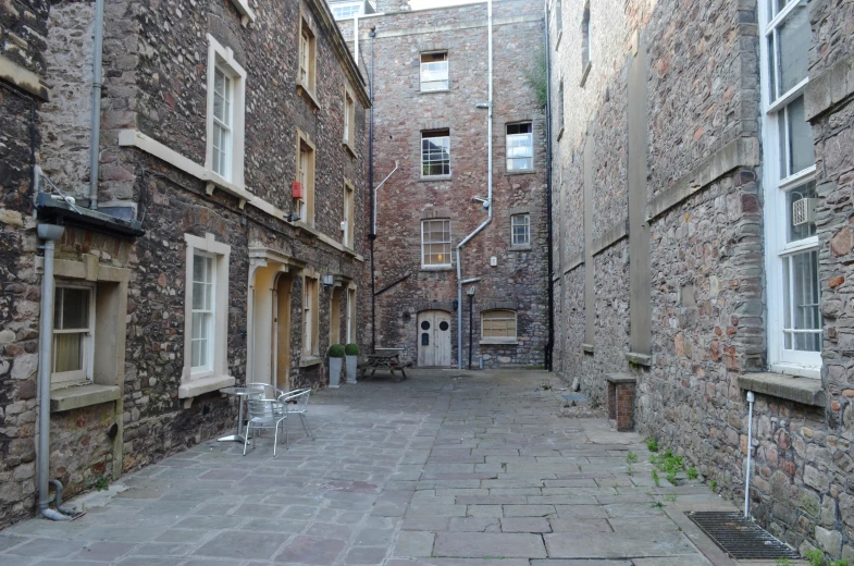 a large brick walkway that leads into another building