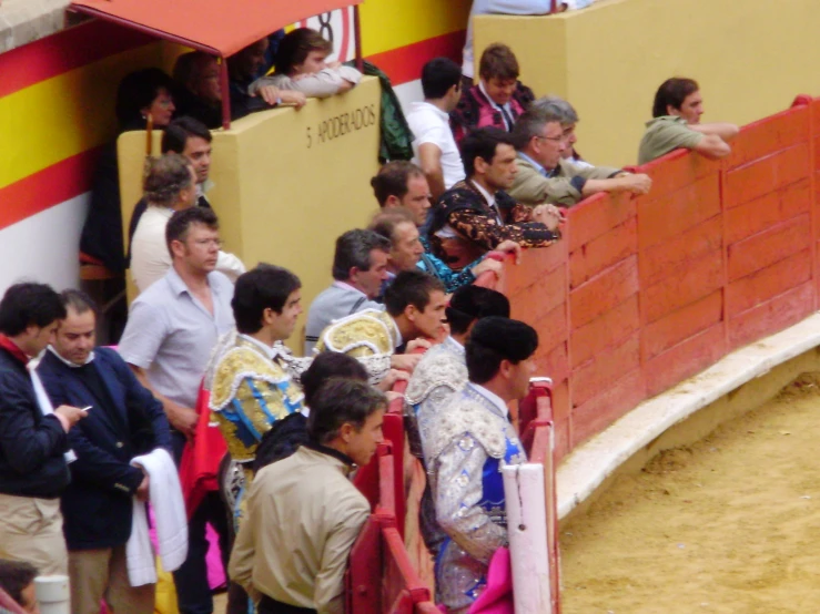 an bullfighter showing its crowd what to do