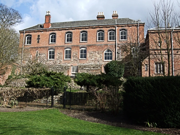 a large building in a park filled with trees