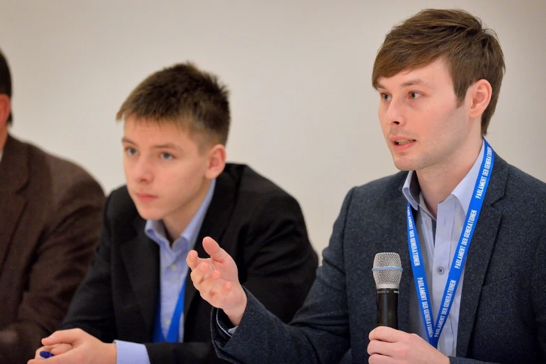 three people in business attire at a table