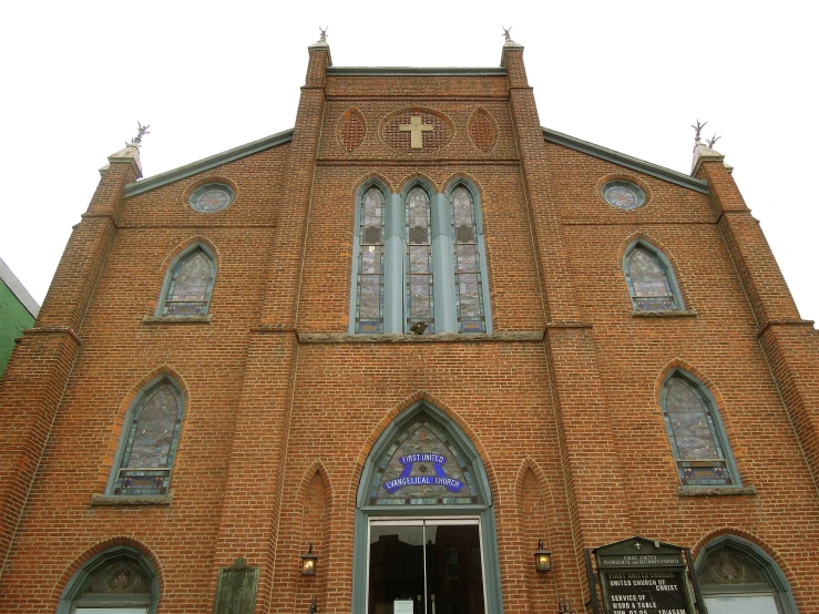 the building is tall and has a large stained glass window