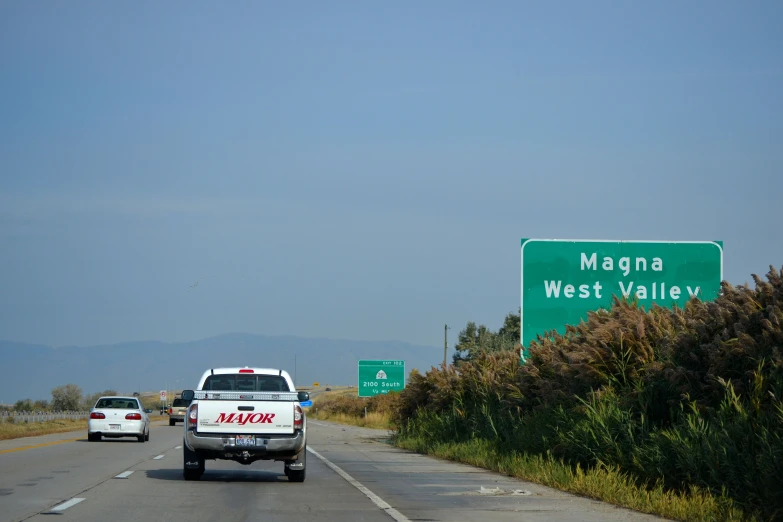 a van driving down a highway near a sign