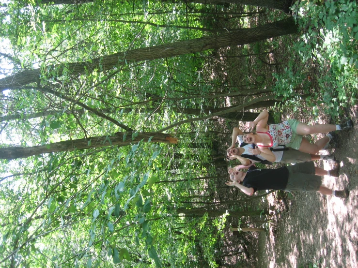 three young people pose in the forest for a po