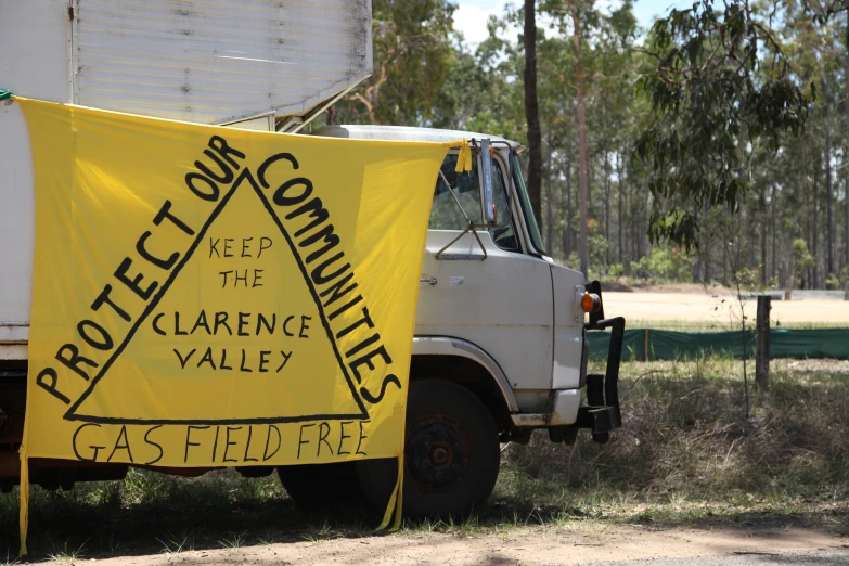 a yellow sign is near a white truck