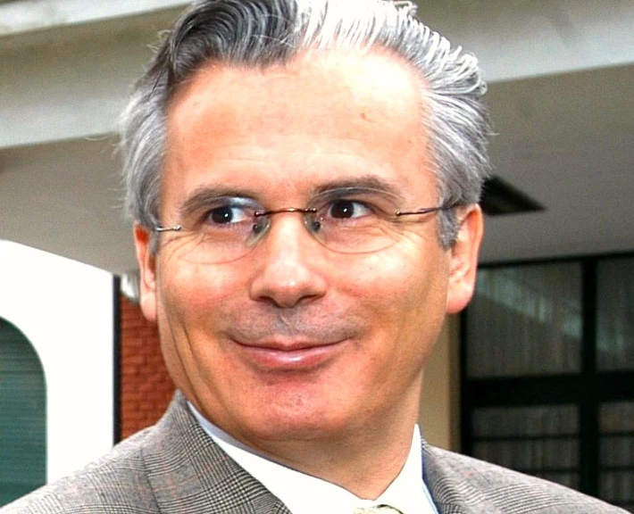 a man in a suit and tie standing outside a building