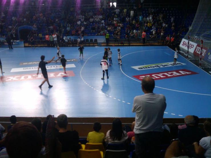 there are several people playing soccer in a stadium