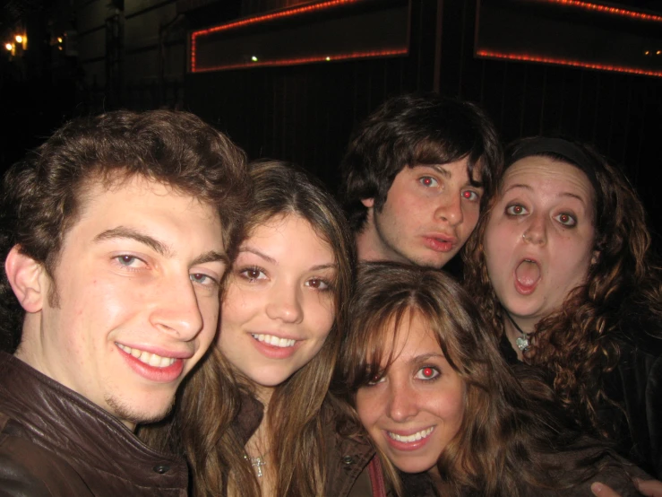 group of young people making silly faces in a bar