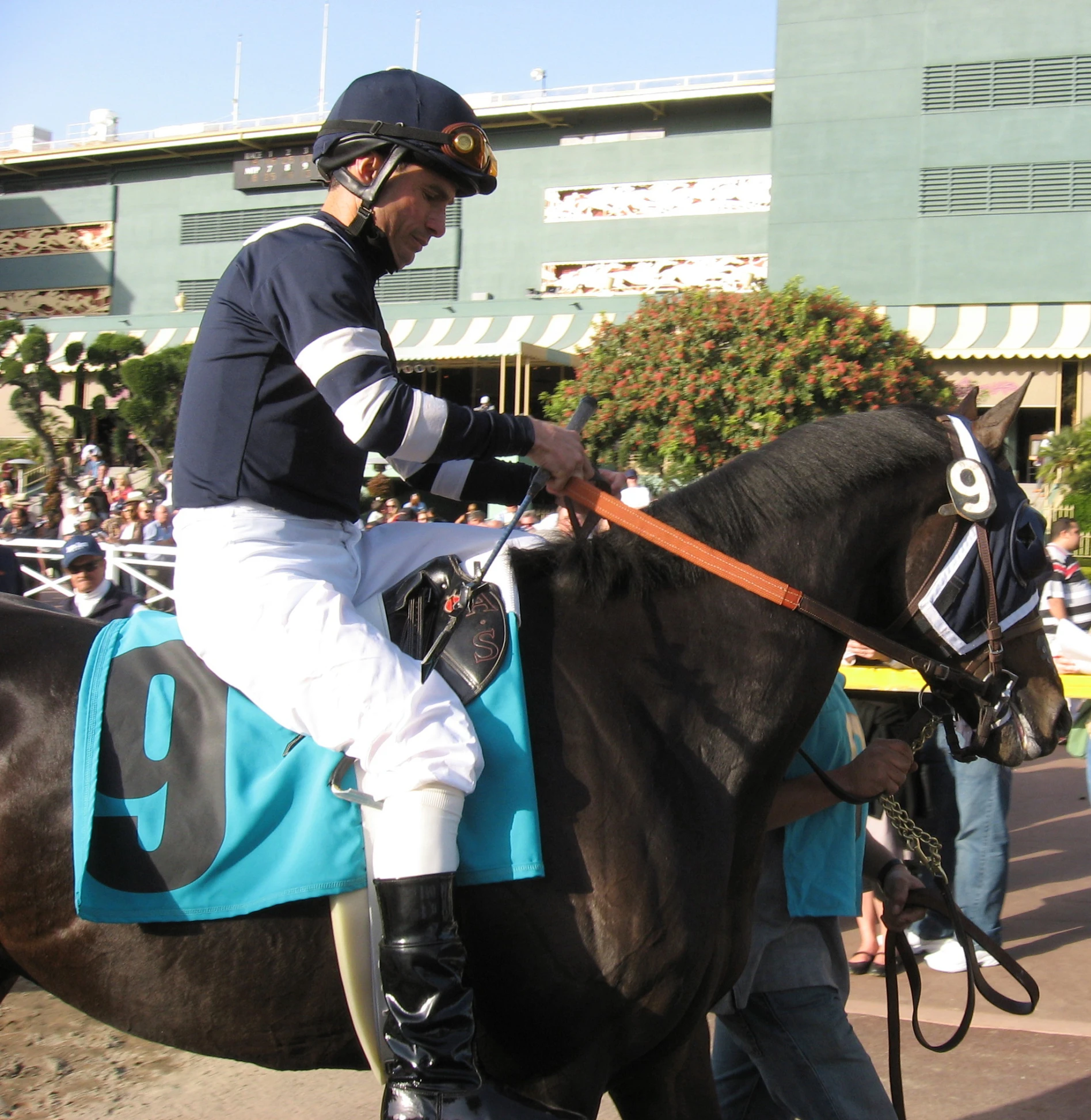 an jockey rides his horse around the track