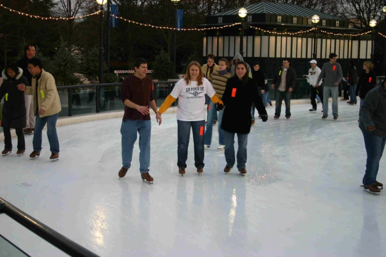 several people on an ice rink having fun